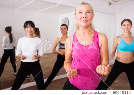 Fitness women practicing zumba movements 60648313