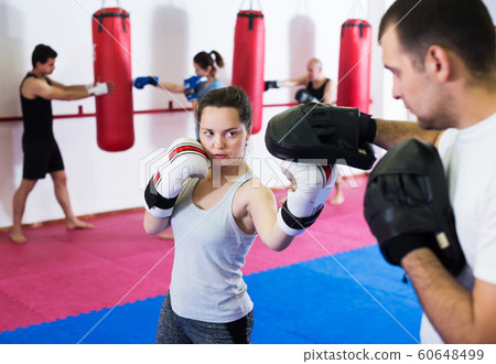 Sportswomen competing in colored boxing gloves 60648499