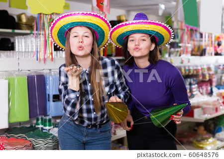 girls have fun trying on festival hats girls have fun trying on festival hats 60648576