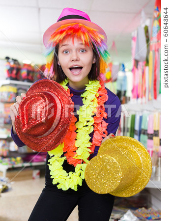 Woman choosing funny headdresses in store Woman choosing funny headdresses in store 60648644