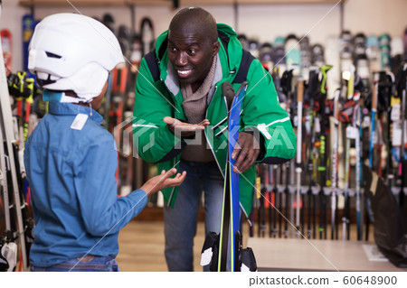 Man choosing ski for son Man choosing ski for son 60648900