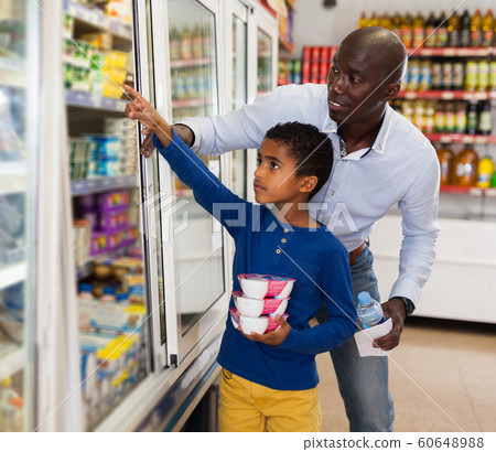 African American man with his son making purchases 60648988