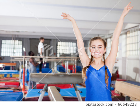 teenage girl rejoicing at her sporting success teenage girl rejoicing at her sporting success 60649228