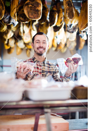 Seller offering displayed sorts of meat 60649280