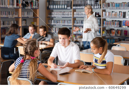 Attentive boys and girls brainstorming in teams 60649299