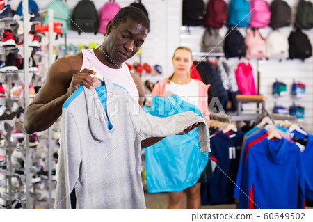 Afro male choosing sport clothes 60649502