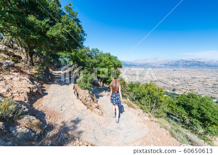 Girl tourist go from the Dikteo Andro Cave also known as birth place of Zeus in Crete 60650613