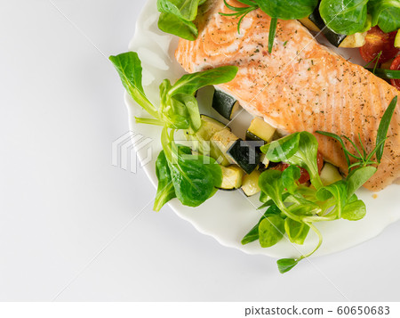 Delicious roasted fish served on white plate Delicious roasted fish served on white plate 60650683