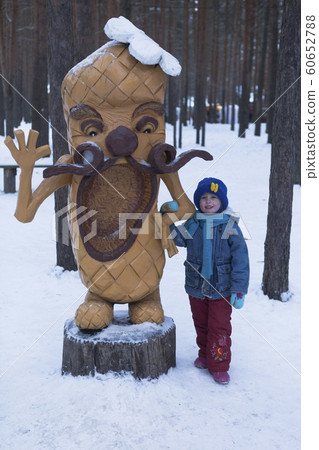A child stands in coved wooden sculpture Lapot in A child stands in coved wooden sculpture Lapot in 60652788