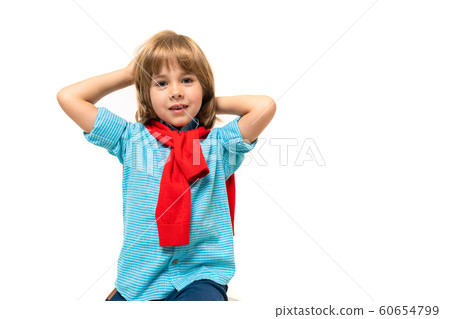 Sports teenager boy in t-shirt with hoody around his neck gesticulates isolated on blue background 60654799