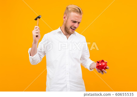 Funny caucasian man have a gift isolated on yellow background 60655535