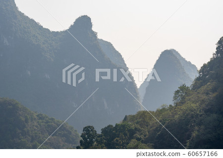 Karst formation and foggy mountain landscape between Guiling and Yangshuo Karst formation and foggy mountain landscape between Guiling and Yangshuo 60657166