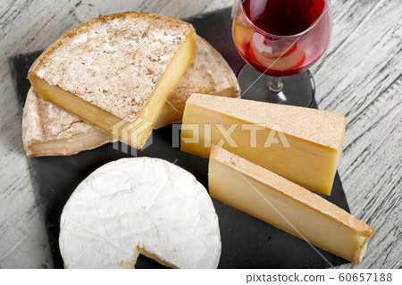 Different french cheeses with a glass of wine Different french cheeses with a glass of wine 60657188