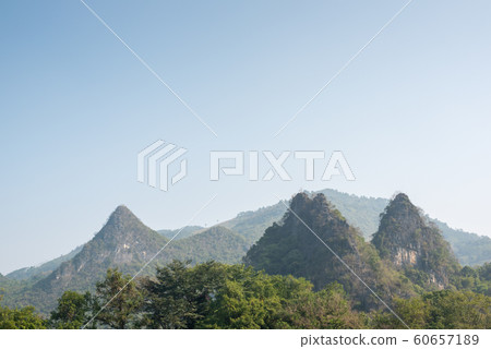Karst formation and foggy mountain landscape between Guiling and Yangshuo Karst formation and foggy mountain landscape between Guiling and Yangshuo 60657189