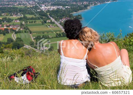 Two women watching view of Lake Annecy Two women watching view of Lake Annecy 60657321