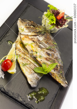 Grilled sea fish. Close-up shot on a white background. 60660337