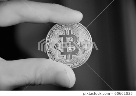 Bitcoin holding by man 60661825
