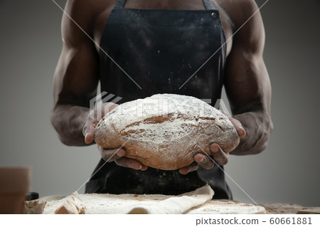 Close up of african-american man cooks bread at craft kitchen 60661881