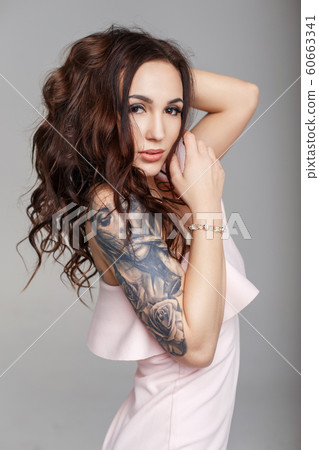 Beautiful funny woman with a haircut with a tattoo Beautiful funny woman with a haircut with a tattoo 60663341