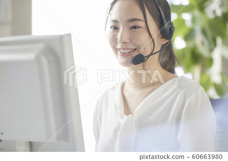 Young woman working at a call center operator Young woman working at a call center operator 60663980