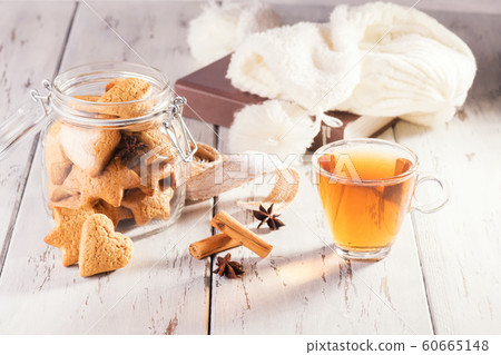 Christmas edible gift: ginger cookies shaped as heart cookies on a shabby natural wooden background. Christmas zero waste. Christmas edible gift: ginger cookies shaped as heart cookies on a shabby natural wooden background. Christmas zero waste. 60665148