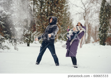 Little girl with parents in a winter park Little girl with parents in a winter park 60665533