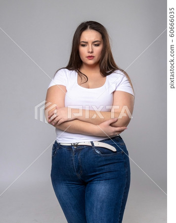 Sad Plus Size Model with long hair posing in studio Sad Plus Size Model with long hair posing in studio 60666035
