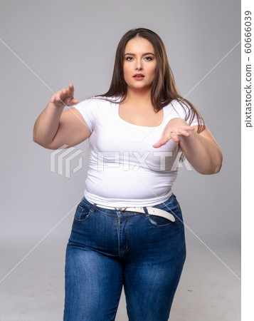 Plus Size Model with long hair posing in studio 60666039