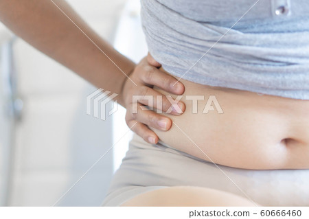 Closeup hand holding abdominal surface woman fat Closeup hand holding abdominal surface woman fat 60666460