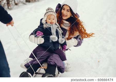 Mother and daughter in a winter park Mother and daughter in a winter park 60666474