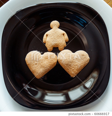 Pile of cookies on a black plate 60666917