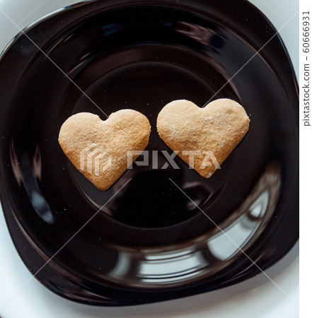 Pile of cookies on a black plate Pile of cookies on a black plate 60666931