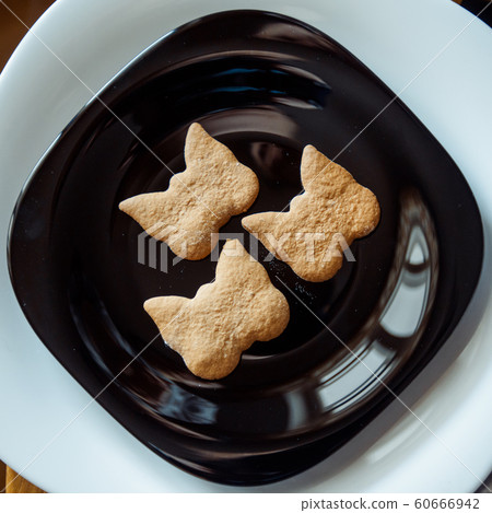 Pile of cookies on a black plate 60666942