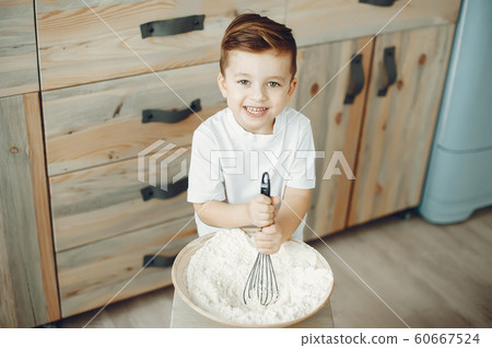 Cute little boy sitting in a kitchen 60667524