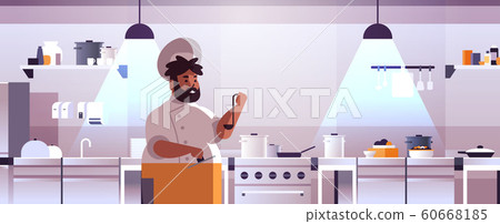 male professional chef cook preparing and tasting dishes african american man in uniform near stove cooking food concept modern restaurant kitchen interior flat portrait horizontal 60668185