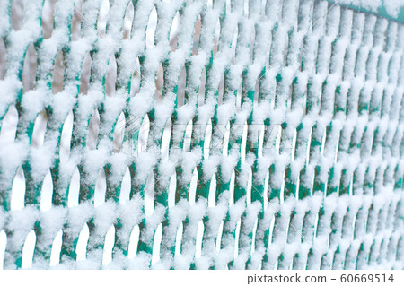 Mesh fence lattice crushed by snow a 60669514