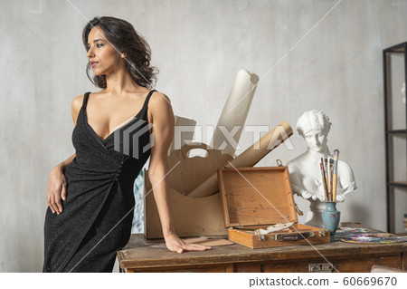 Attractive girl posing for camera in art room Attractive girl posing for camera in art room 60669670