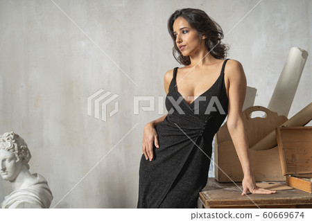 Caucasian attractive woman posing for camera in art room Caucasian attractive woman posing for camera in art room 60669674