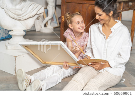 Beautiful mother having fun with her little daughter Beautiful mother having fun with her little daughter 60669901