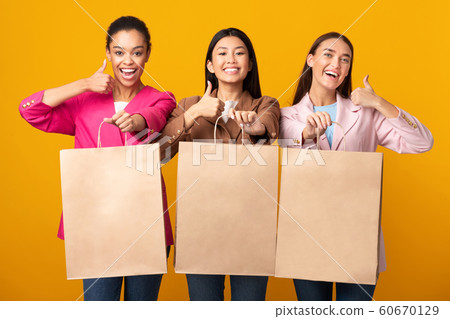Three Women Showing Blank Shopper Bags Gesturing Thumbs-Up, Studio, Mockup 60670129