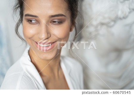 Smiling young lady posing for camera near monument 60670545