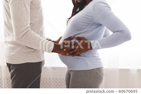 African american man toucing his pregnant wife belly 60670695