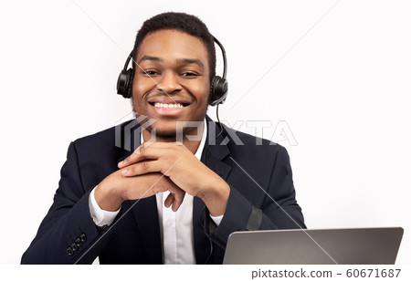Cheerful consultant with headset looking at you Cheerful consultant with headset looking at you 60671687