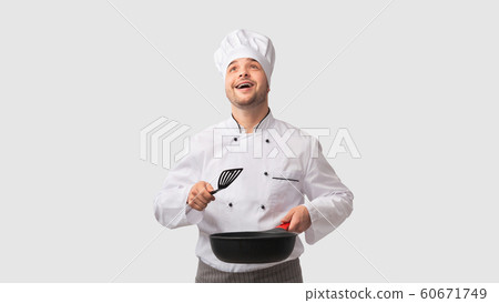 Cook Man Holding Pan And Spatula Looking Up, White Background Cook Man Holding Pan And Spatula Looking Up, White Background 60671749