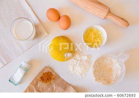 Ingredients for yellow dough on kitchen white table Ingredients for yellow dough on kitchen white table 60672693