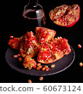 Pomegranate with Christmas decorations on dark 60673124