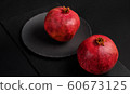 Pomegranate with Christmas decorations on dark 60673125