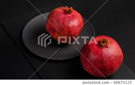 Pomegranate with Christmas decorations on dark 60673125