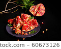 Pomegranate with Christmas decorations on dark 60673126