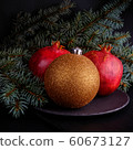 Pomegranate with Christmas decorations on dark 60673127